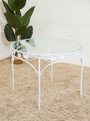 Vintage Wrought Iron Patio Dining Table with Leaf Motif Aqua Cushions and Glass Top
