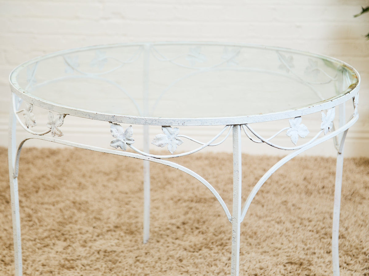Vintage Wrought Iron Patio Dining Table with Leaf Motif Aqua Cushions and Glass Top