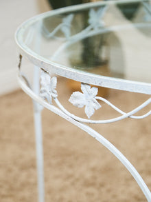 Vintage Wrought Iron Patio Dining Table with Leaf Motif Aqua Cushions and Glass Top