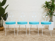 Vintage Wrought Iron Patio Dining Table with Leaf Motif Aqua Cushions and Glass Top