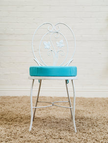 Vintage Wrought Iron Patio Dining Table with Leaf Motif Aqua Cushions and Glass Top