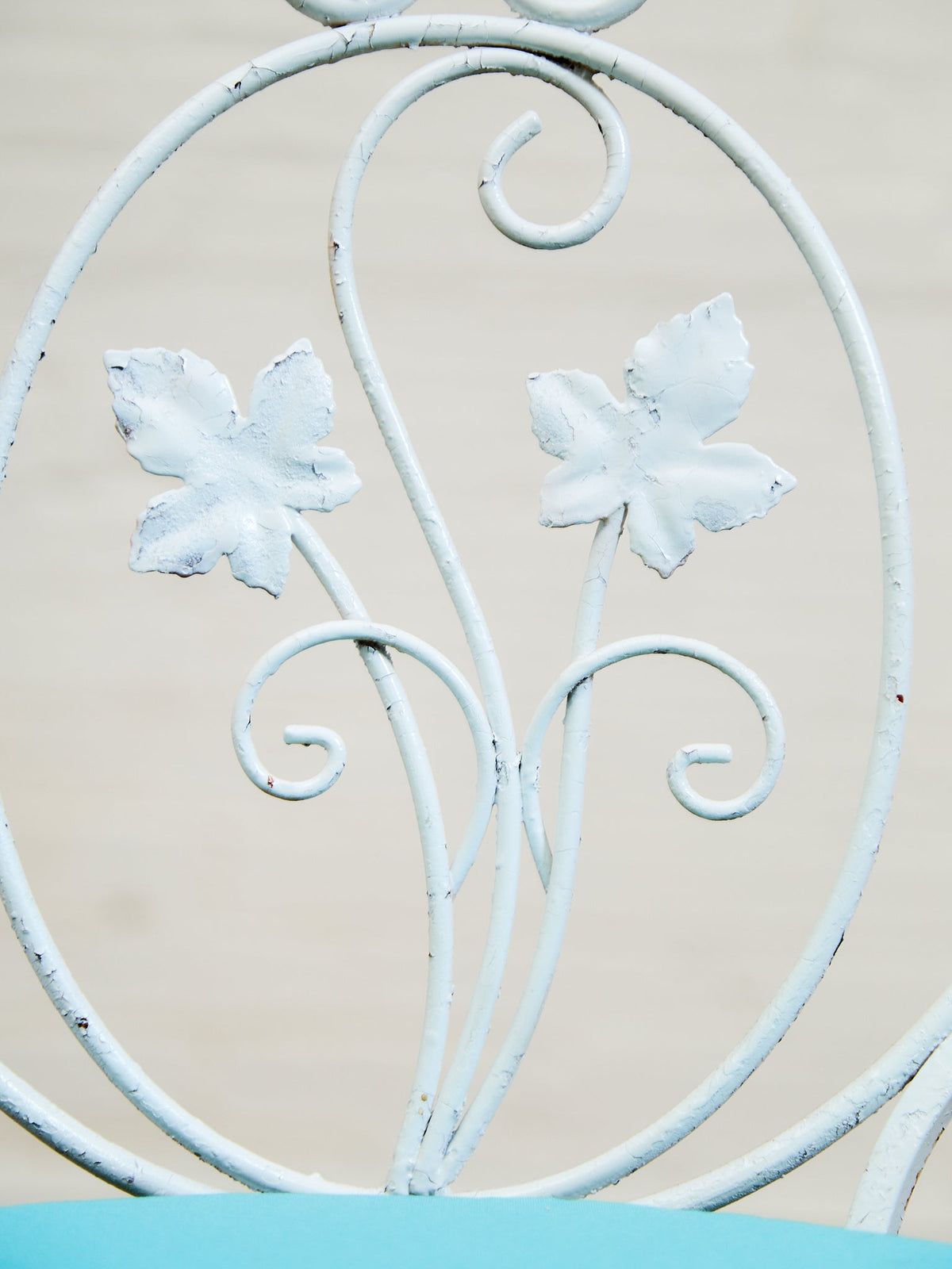 Vintage Wrought Iron Patio Dining Table with Leaf Motif Aqua Cushions and Glass Top