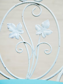 Vintage Wrought Iron Patio Dining Table with Leaf Motif Aqua Cushions and Glass Top